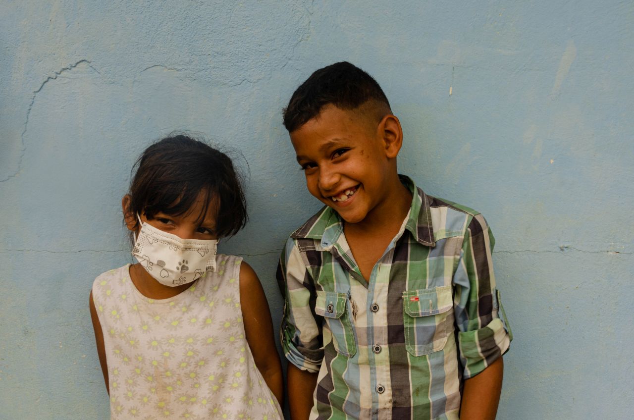 Brother and sister share moment together outside the shelter in Colombia