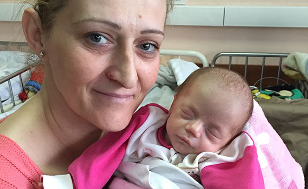 A mother with her newborn daughter treated with surfactant from AmeriCares and AbbVie at the University Clinical Center Kosovo&rsquo;s Neonatal Intensive Care Unit.