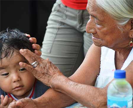A grandmother tends to a hurt child.